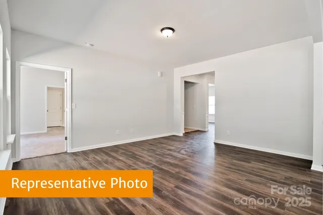 a view of an empty room and wooden floor