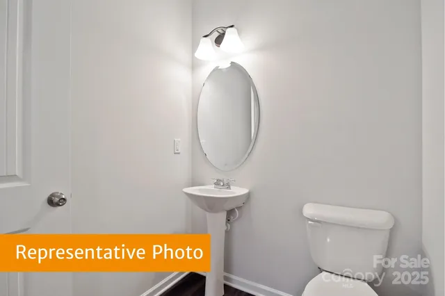 a bathroom with a toilet and a mirror