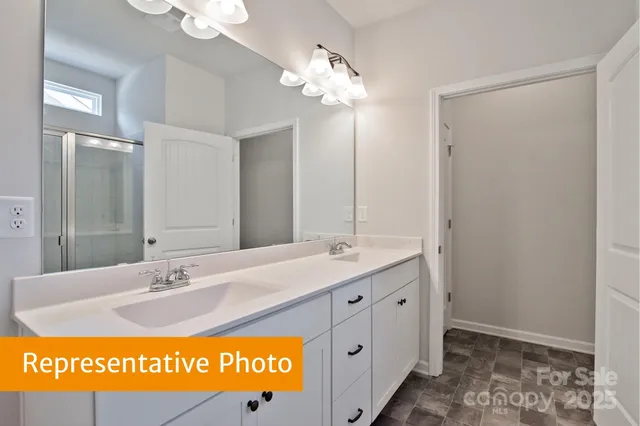 a bathroom with a sink mirror and vanity