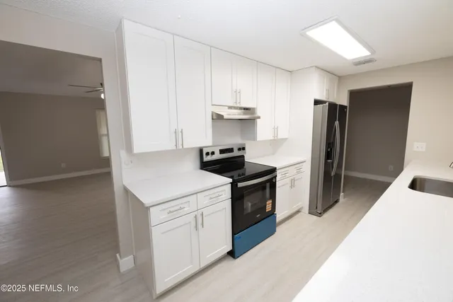 a kitchen with a stove and a refrigerator