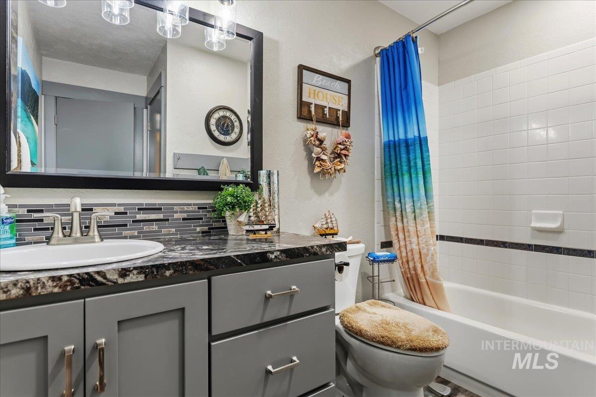 6323 Foothill Road Star, ID 83669 - Photo 24 of 50 Bathroom featuring a gray vanity with chrome hardware, an undermount sink, and a dark patterned countertop