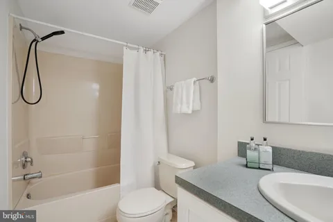 a view of an empty room with wooden floor and entryway
