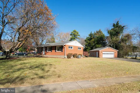 a large house with a big yard and large trees