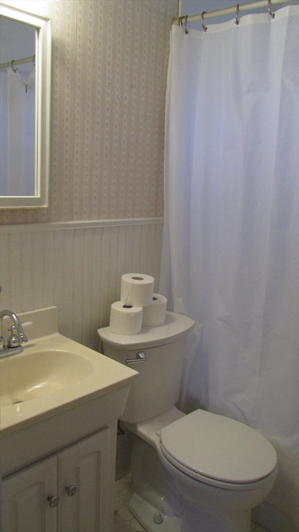 2 Bertha Street Hudson, MA 01749 - Photo 16 of 17 a white toilet sitting next to a bathroom sink