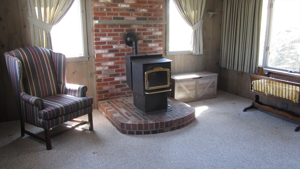 2 Bertha Street Hudson, MA 01749 - Photo 5 of 17 a living room with furniture a fireplace and a window