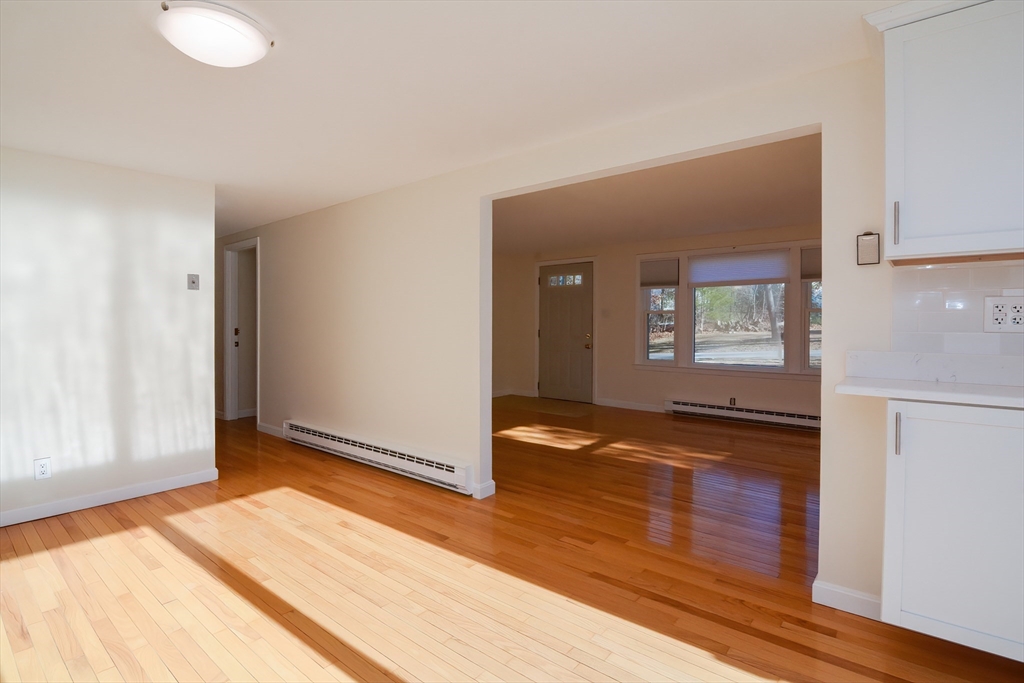 25 Indian Run Road Bellingham, MA 02019 - Photo 13 of 29 a view of a livingroom with wooden floor and kitchen space