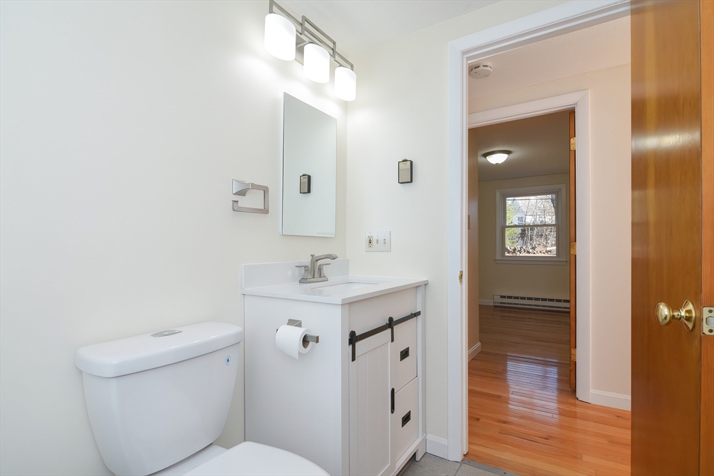 25 Indian Run Road Bellingham, MA 02019 - Photo 18 of 29 a bathroom with a sink a toilet a vanity and mirror