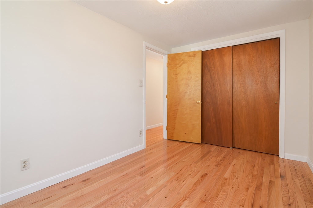 25 Indian Run Road Bellingham, MA 02019 - Photo 25 of 29 a view of an empty room with wooden floor and a window