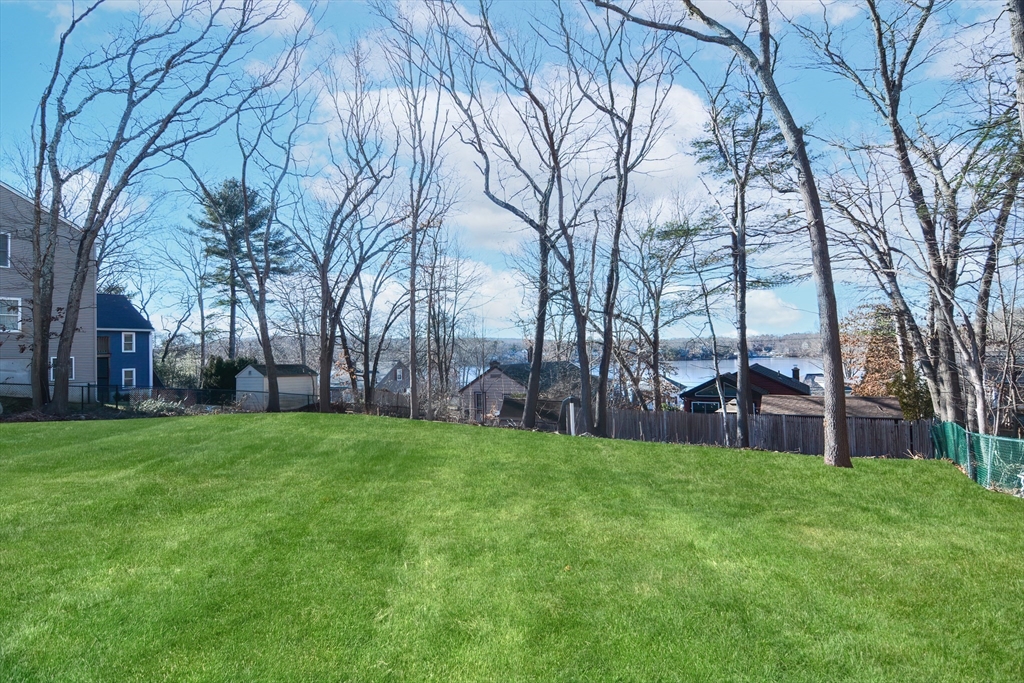 25 Indian Run Road Bellingham, MA 02019 - Photo 3 of 29 a view of a backyard with large trees