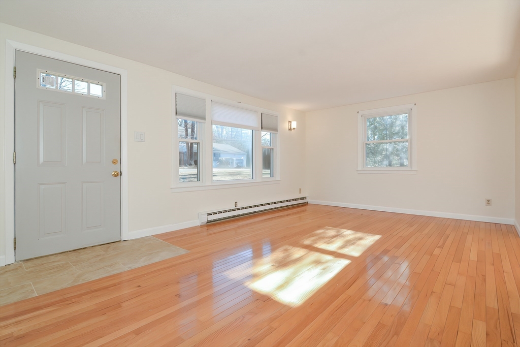 25 Indian Run Road Bellingham, MA 02019 - Photo 9 of 29 an empty room with wooden floor and windows