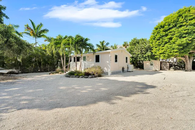 a view of a house with a yard and plant