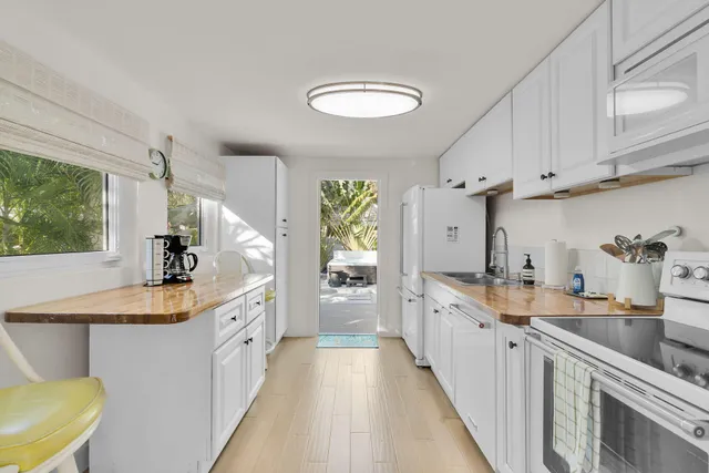 a large kitchen with kitchen island a sink stainless steel appliances and cabinets