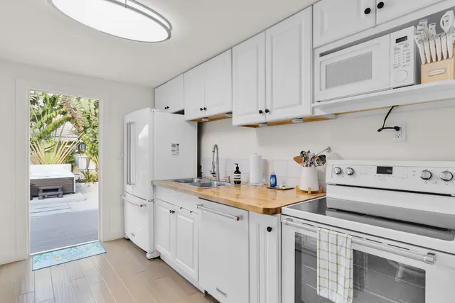 a kitchen with stainless steel appliances granite countertop a sink a stove and a refrigerator