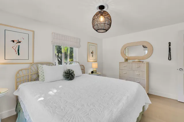 a bedroom with a large bed and a chandelier