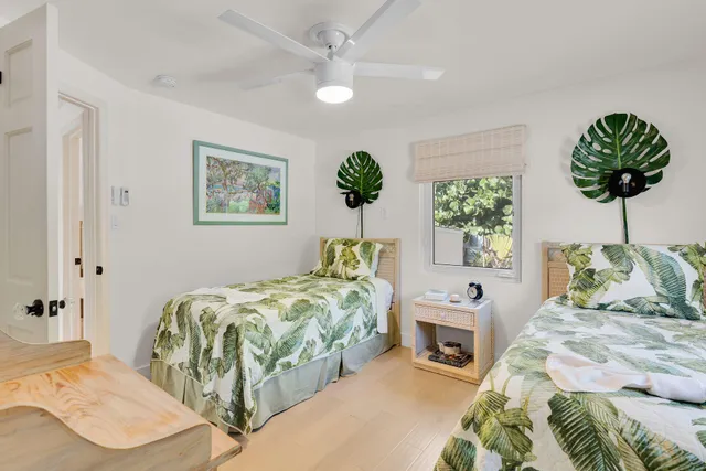 a bedroom with a bed a chandelier and a couch