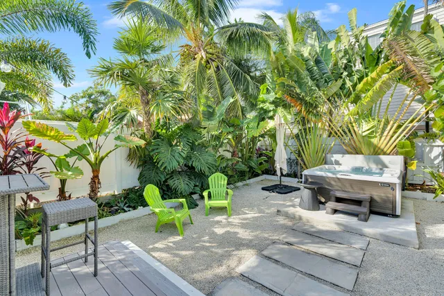 a backyard of a house with barbeque oven table and chairs