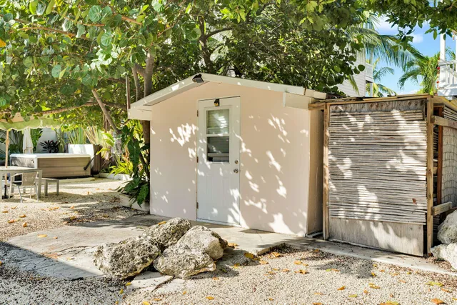 a view of a entrance gate of the house and trees