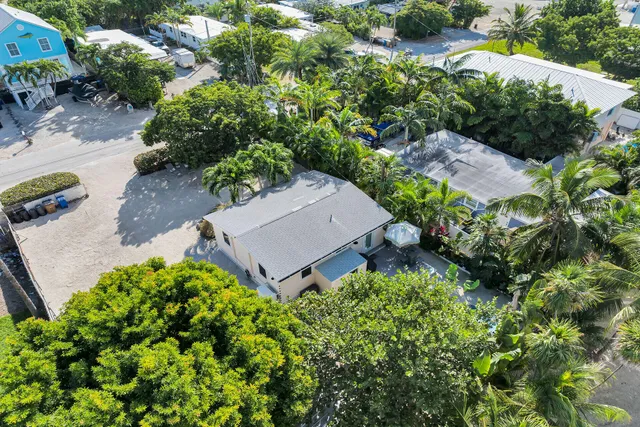 an aerial view of a house with a yard and garden