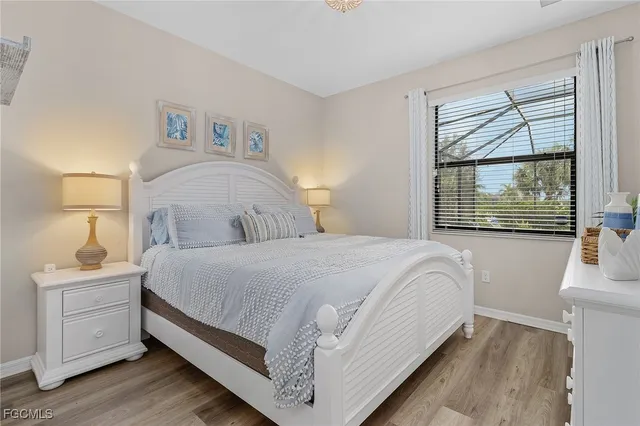 a bedroom with a bed a couch and a potted plant