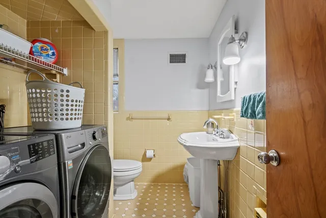 a bathroom with a sink toilet and a mirror