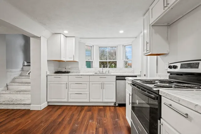 a dining room with furniture and wooden floor