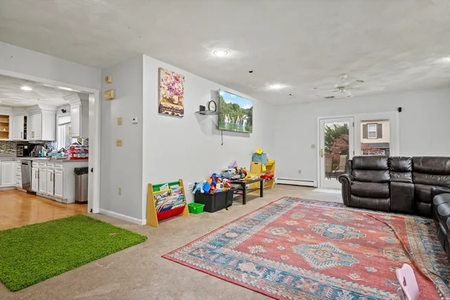 a living room with furniture and a dining table with wooden floor