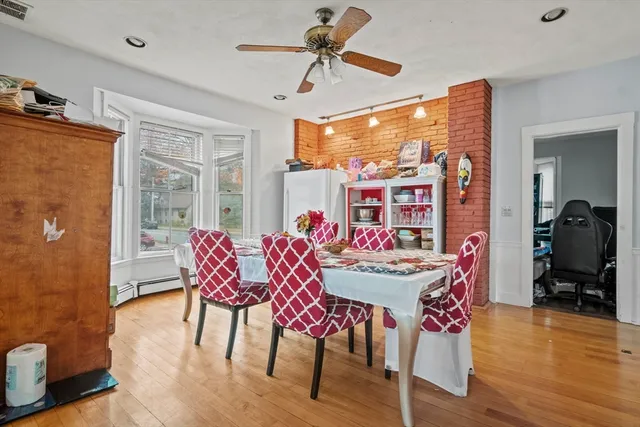 a view of a dining room with furniture window and wooden floor