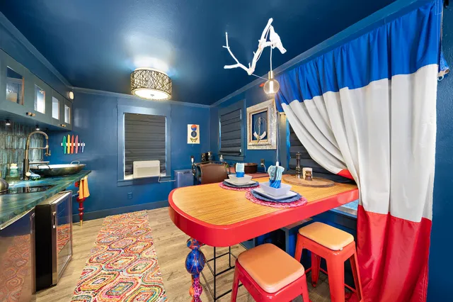 a view of a dining room with furniture and a chandelier