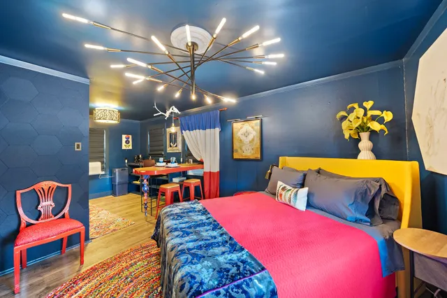 a living room with a table chairs and a chandelier
