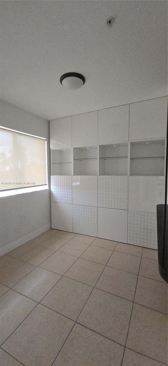 21000 Southwest 87th Avenue, Unit 308 Cutler Bay, FL 33189 - Photo 11 of 30 a view of a livingroom with an empty space and a window