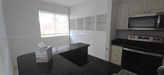 a kitchen with stainless steel appliances wooden cabinets and a stove top oven