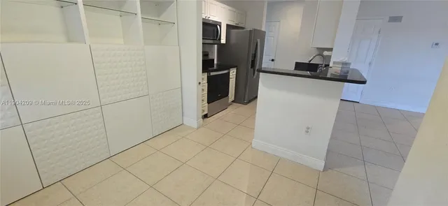 a kitchen with a refrigerator and a sink