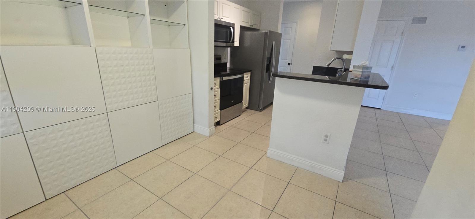21000 Southwest 87th Avenue, Unit 308 Cutler Bay, FL 33189 - Photo 15 of 30 a kitchen with a refrigerator and a sink