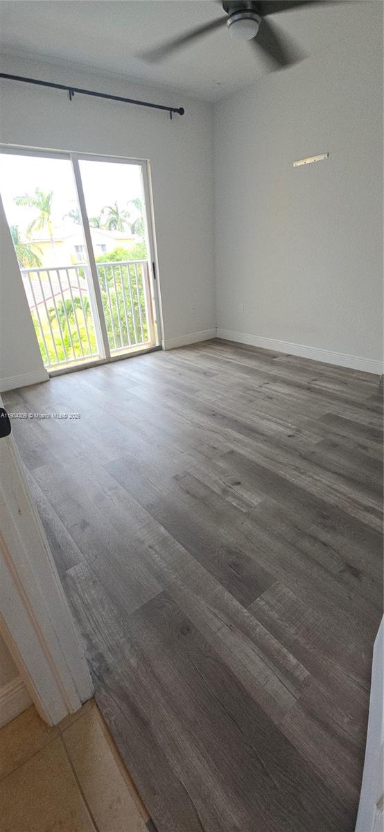 21000 Southwest 87th Avenue, Unit 308 Cutler Bay, FL 33189 - Photo 20 of 30 a view of an empty room with wooden floor and windows