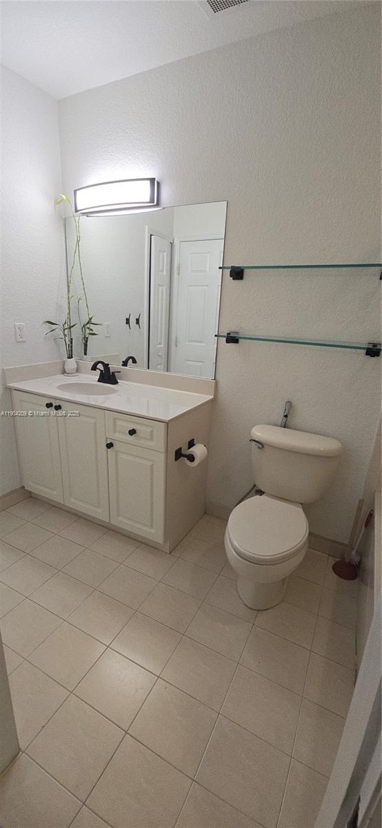 21000 Southwest 87th Avenue, Unit 308 Cutler Bay, FL 33189 - Photo 23 of 30 a bathroom with a granite countertop toilet sink and mirror