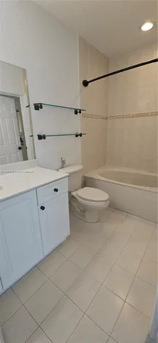 a bathroom with a toilet a sink and shower