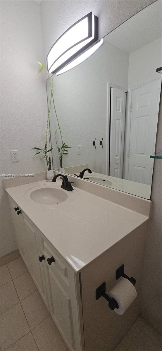 21000 Southwest 87th Avenue, Unit 308 Cutler Bay, FL 33189 - Photo 26 of 30 a bathroom with a sink and a mirror