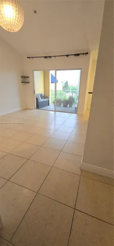 a view of a livingroom with wooden floor and a large window