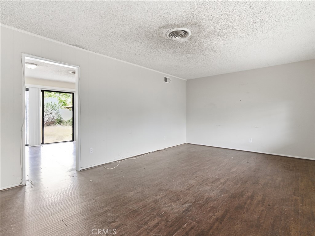 10127 Foothill Boulevard Sylmar, CA 91342 - Photo 24 of 33 an empty room with wooden floor and windows