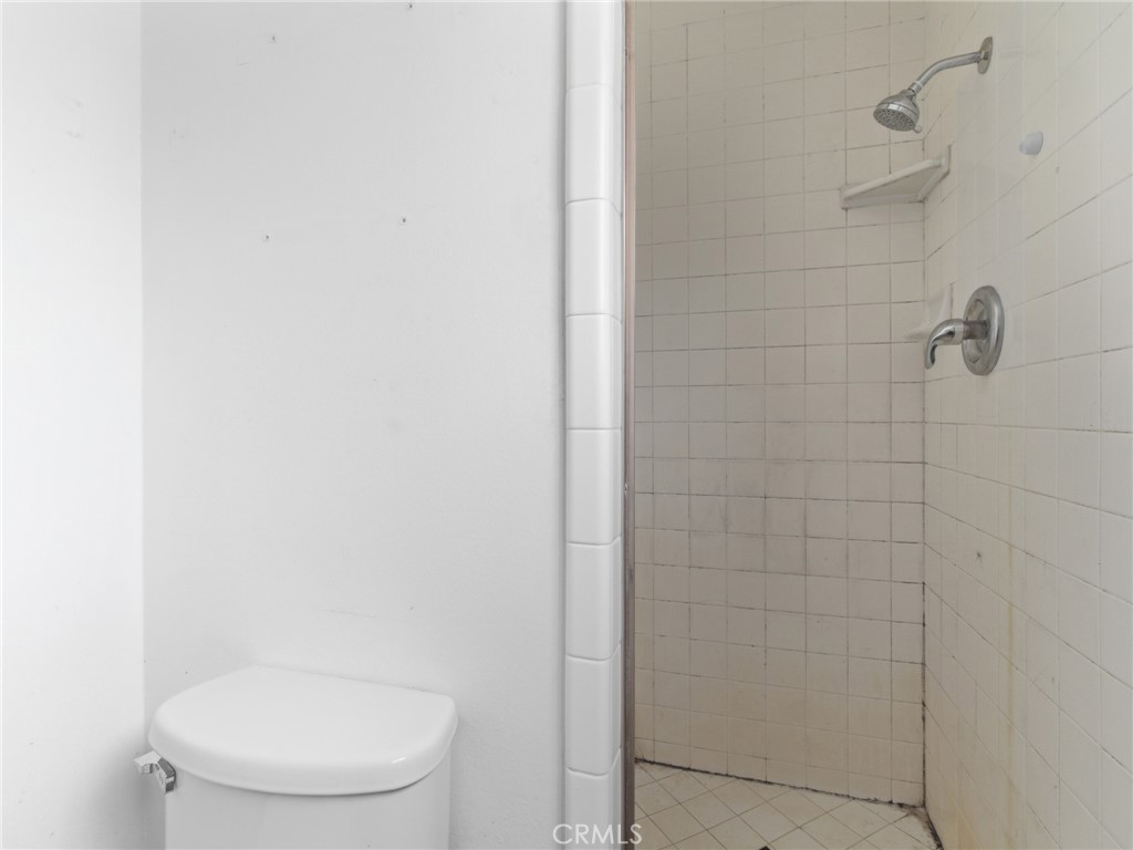 10127 Foothill Boulevard Sylmar, CA 91342 - Photo 28 of 33 a white toilet sitting next to a shower