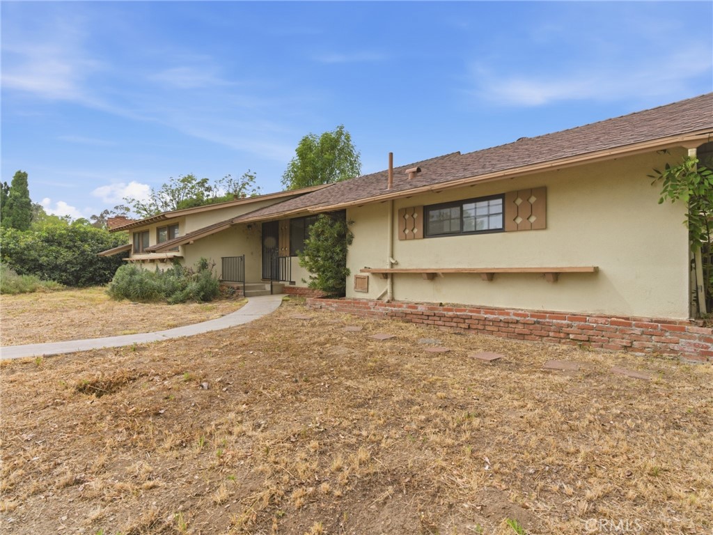 10127 Foothill Boulevard Sylmar, CA 91342 - Photo 3 of 33 a front view of a house with a yard