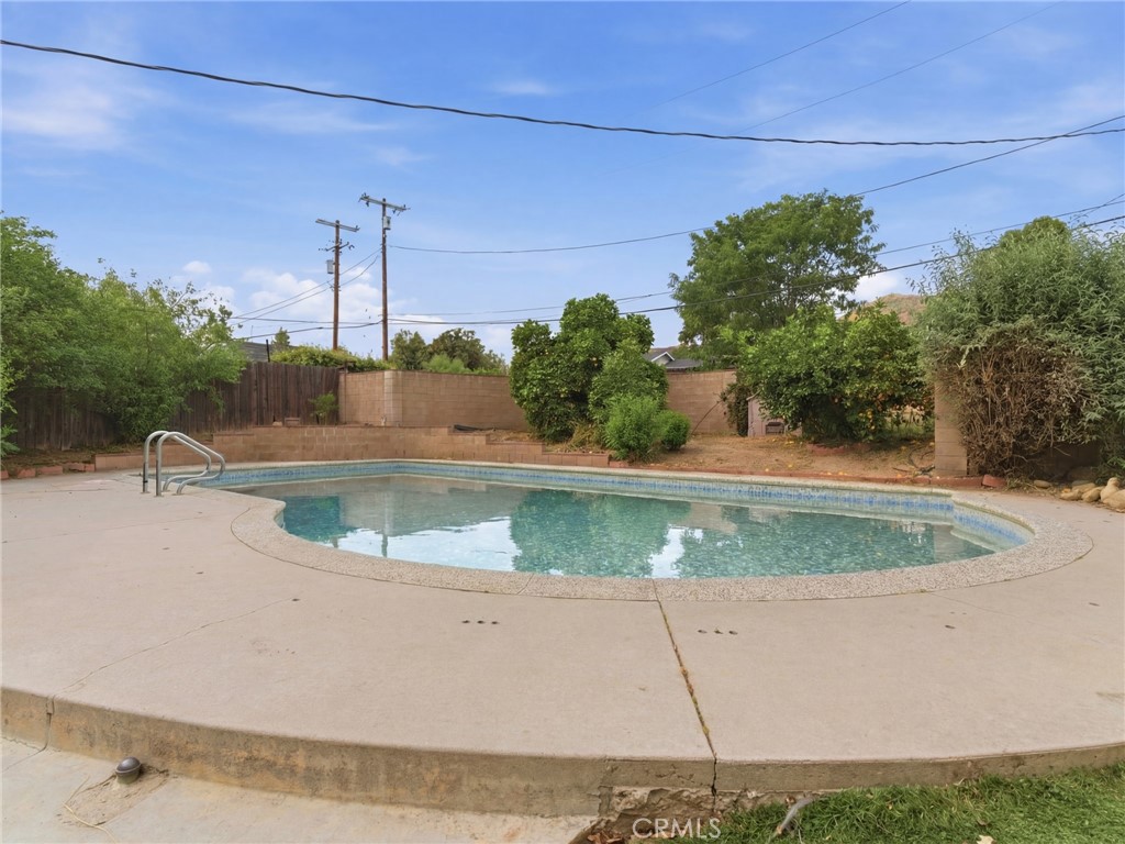 10127 Foothill Boulevard Sylmar, CA 91342 - Photo 31 of 33 a view of a swimming pool with a yard