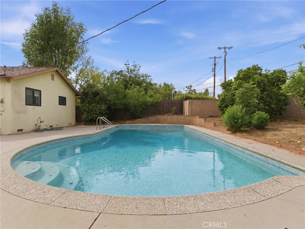 10127 Foothill Boulevard Sylmar, CA 91342 - Photo 32 of 33 a view of a swimming pool with a yard
