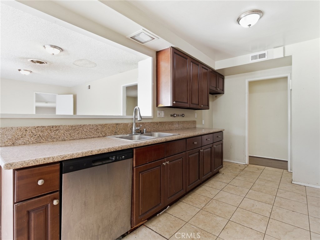 10127 Foothill Boulevard Sylmar, CA 91342 - Photo 9 of 33 a spacious bathroom with a granite countertop sink and a mirror