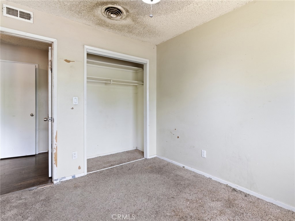 10127 Foothill Boulevard Sylmar, CA 91342 - Photo 10 of 33 an empty room with closet and mirror