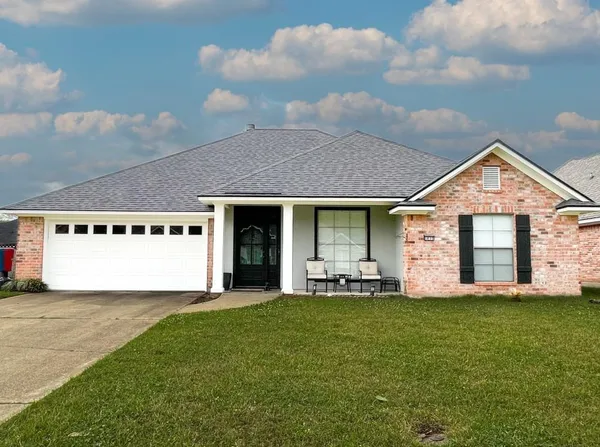 a front view of a house with a yard and garage