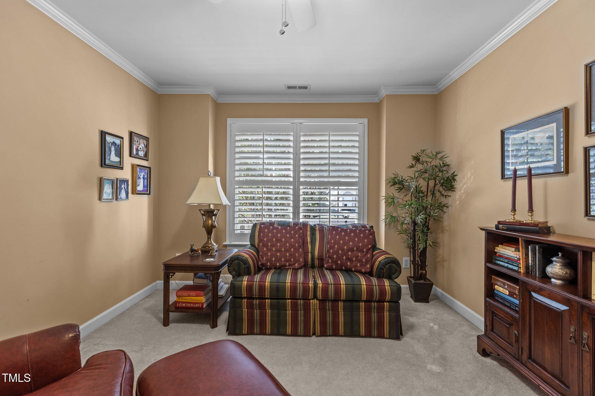 206 Nouveau Avenue Raleigh, NC 27615 - Photo 11 of 61 a living room with furniture a window and a flat screen tv