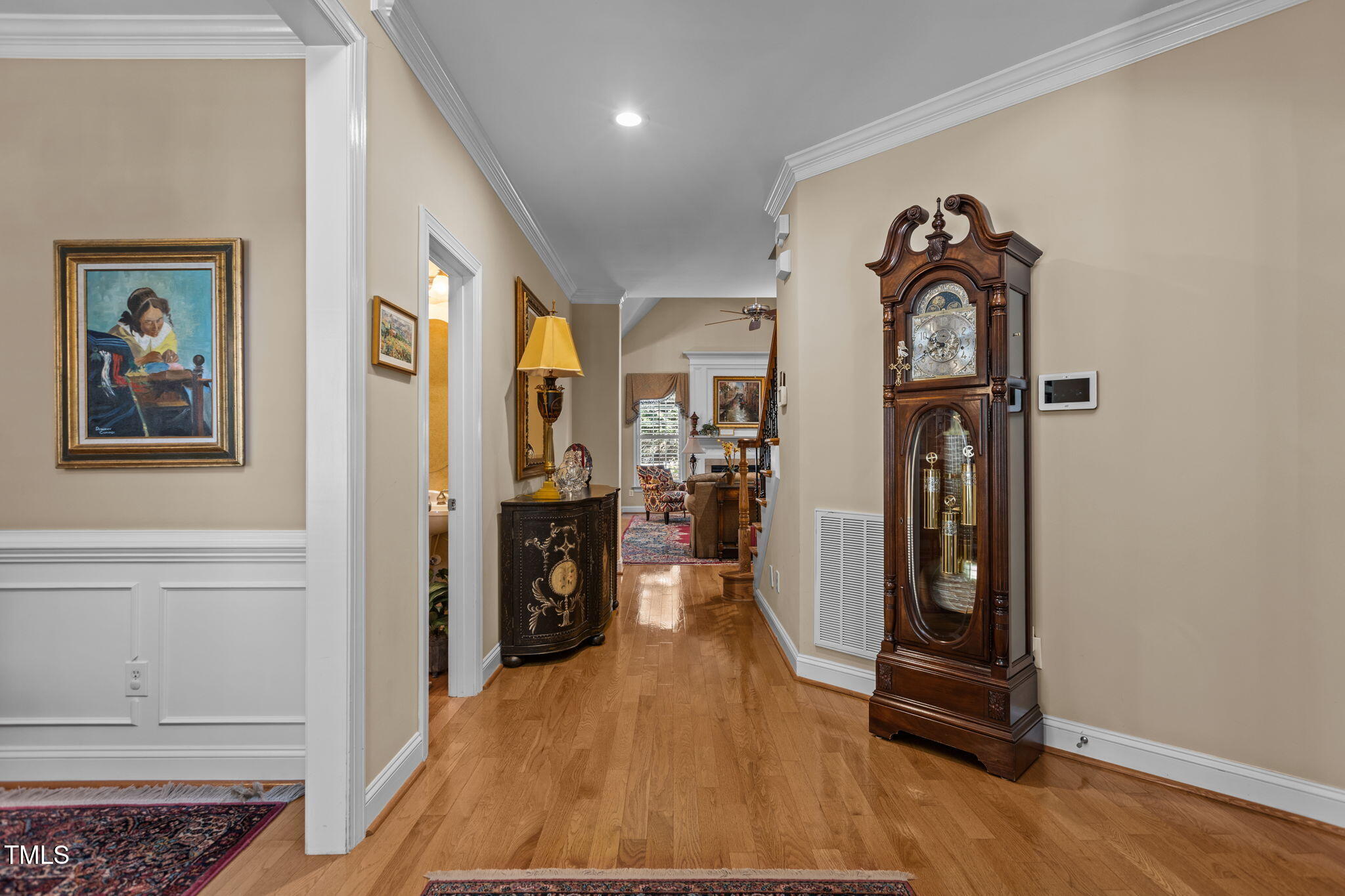 206 Nouveau Avenue Raleigh, NC 27615 - Photo 18 of 61 a view of a hallway with wooden floor and windows