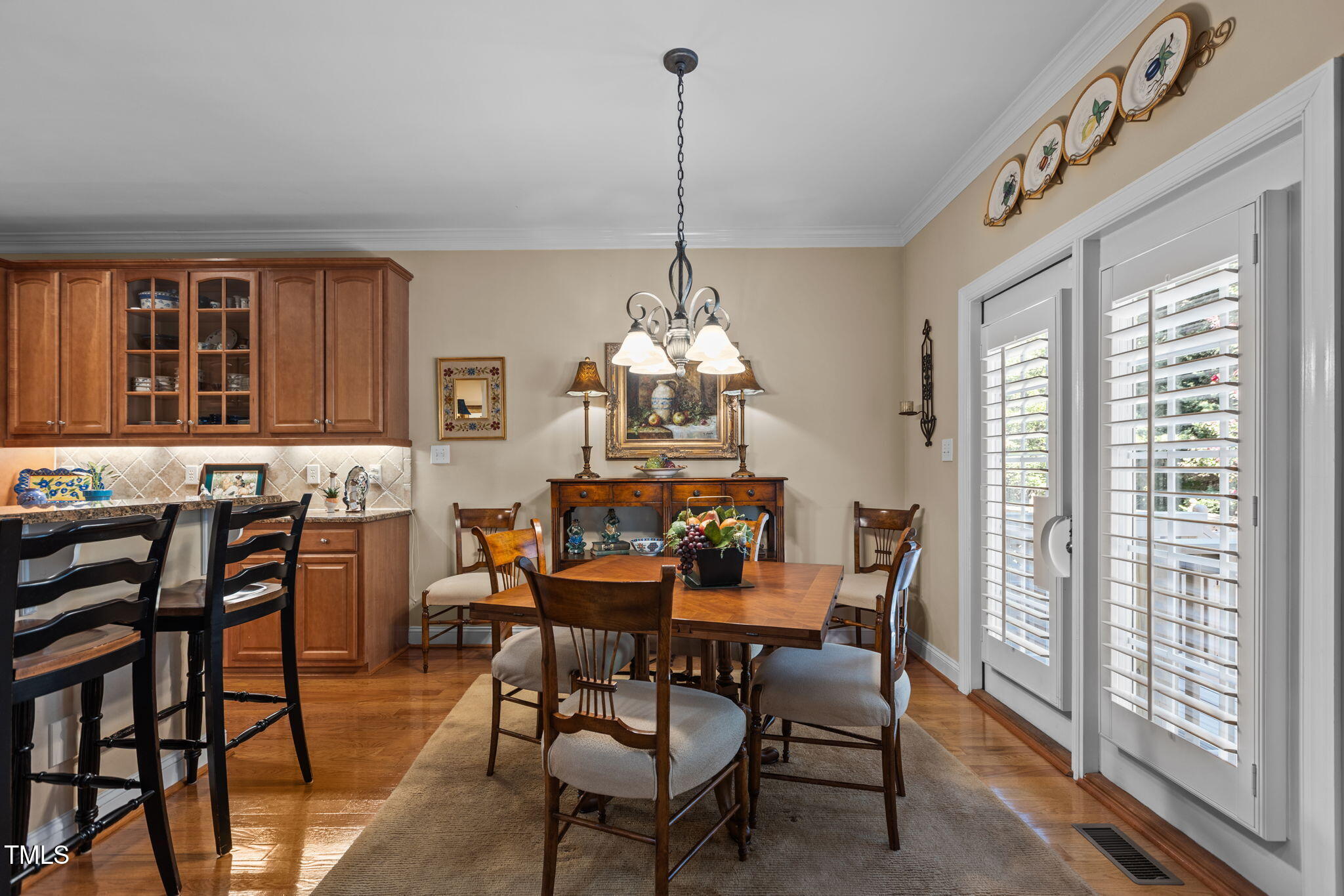 206 Nouveau Avenue Raleigh, NC 27615 - Photo 27 of 61 a dining room with furniture a chandelier and wooden floor