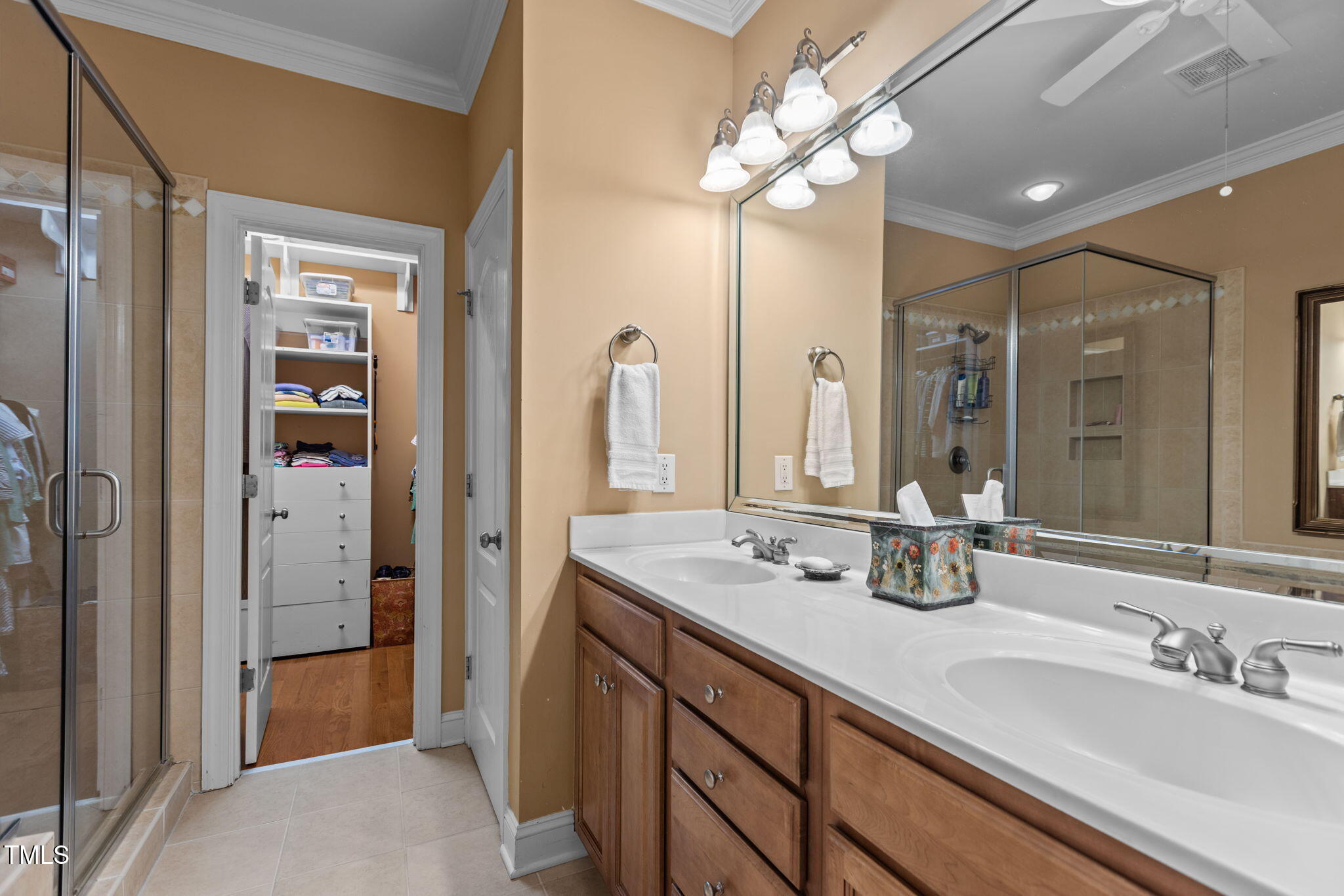 206 Nouveau Avenue Raleigh, NC 27615 - Photo 37 of 61 a bathroom with a double vanity sink a large mirror and shower